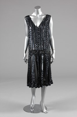 Lot 26 - A sequined black chiffon flapper dress, circa...