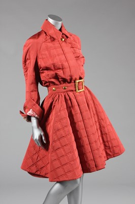 Lot 153 - A Rochas couture brick-red silk quilted coat,...