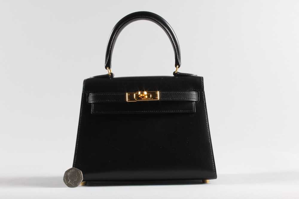 Lot 27 - An Hermès black box-calf leather miniature...