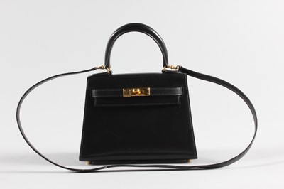 Lot 27 - An Hermès black box-calf leather miniature...
