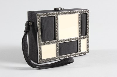 Lot 7 - A Chanel black faille and white enamelled...