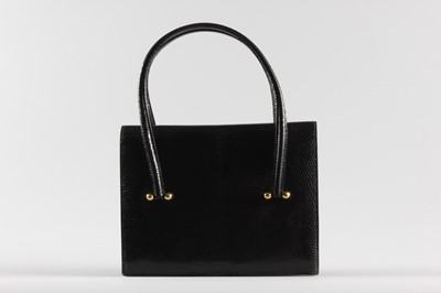 Lot 24 - An Hermès black lizard handbag, late 1960s,...