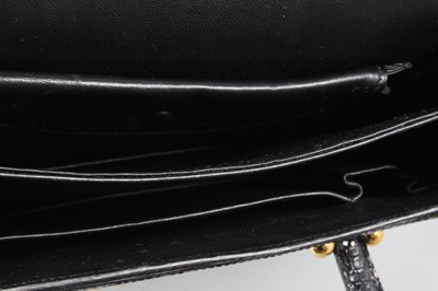 Lot 24 - An Hermès black lizard handbag, late 1960s,...