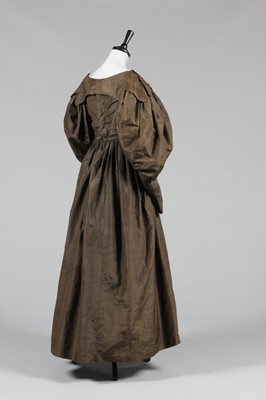 Lot 43 - A brown taffeta dress, circa 1835, with gigot...