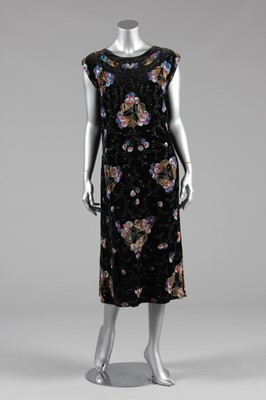 Lot 80 - An embroidered and beaded black velvet dress,...