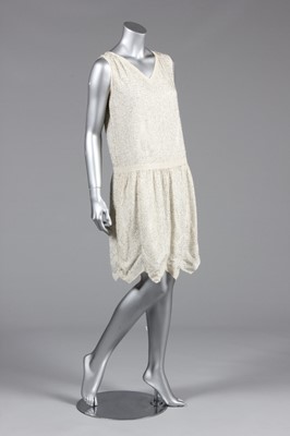 Lot 84 - A beaded flapper dress, late 1920s, the crisp,...