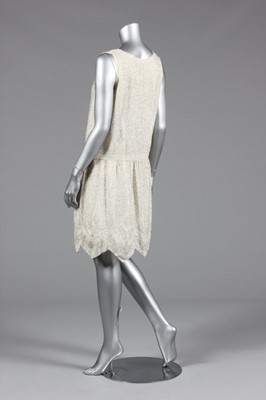 Lot 84 - A beaded flapper dress, late 1920s, the crisp,...