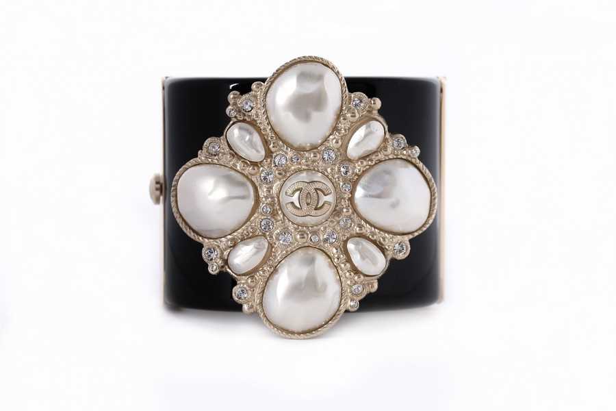 Lot 11 - A Chanel black resin cuff bracelet, 'Coco Rock'...