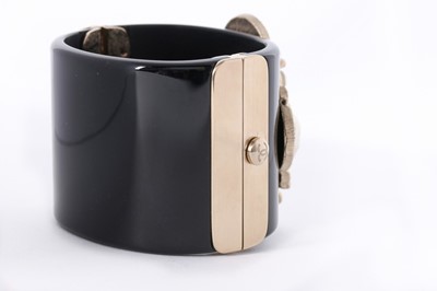 Lot 11 - A Chanel black resin cuff bracelet, 'Coco Rock'...