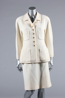 Lot 87 - A Chanel cream tweed suit, 1980s, Boutique...