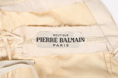 Lot 46 - A Pierre Balmain ivory faille cocktail dress,...