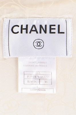 Lot 42 - A Chanel ivory bouclé wool suit, 2006,...