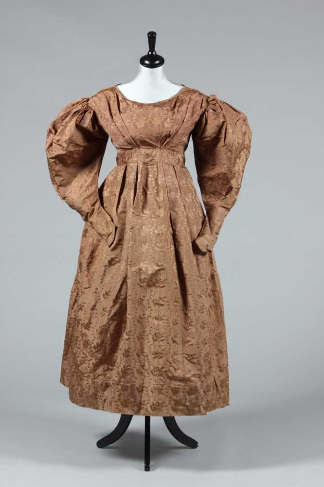 Lot 155 - A brown silk damask gown, circa 1830, with...