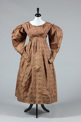 Lot 155 - A brown silk damask gown, circa 1830, with...