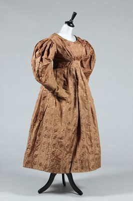 Lot 155 - A brown silk damask gown, circa 1830, with...