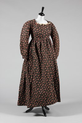 Lot 157 - A printed wool day dress, the style early 19th...