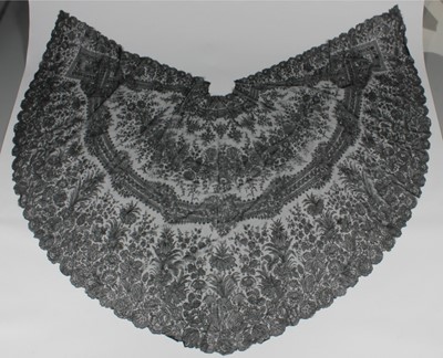 Lot 521 - A fine black Chantilly lace semi-circular cape,...