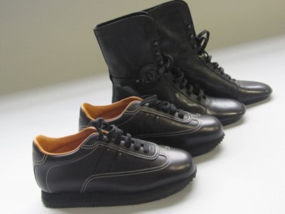 Lot 210 - A pair of unworn Chanel black leather ankle...