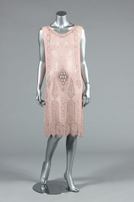 Lot 245 - A pale pink beaded flapper dress, late 1920s,...