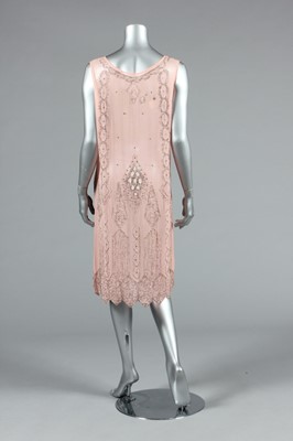 Lot 245 - A pale pink beaded flapper dress, late 1920s,...
