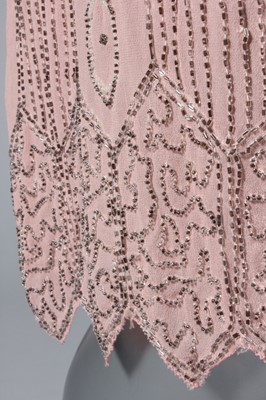 Lot 245 - A pale pink beaded flapper dress, late 1920s,...