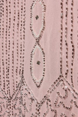 Lot 245 - A pale pink beaded flapper dress, late 1920s,...