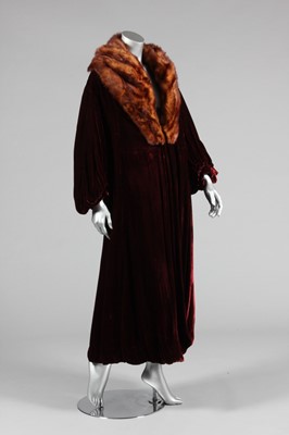 Lot 248 - A deep burgundy velvet evening coat with fur...