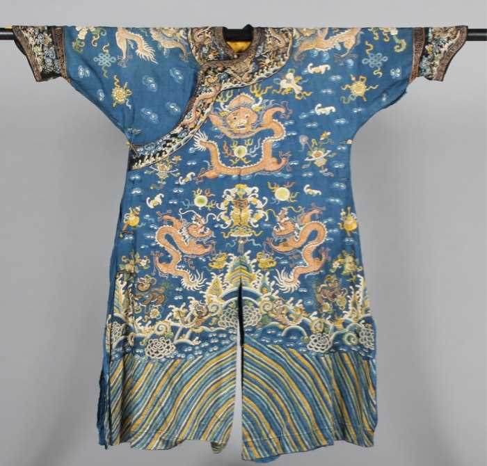 Lot 215 - An embroidered blue silk damask dragon robe,