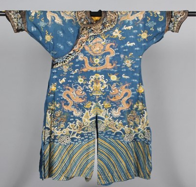 Lot 215 - An embroidered blue silk damask dragon robe,...