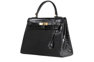 Lot 57 - An Hermès black crocodile Kelly bag, 1950s,...