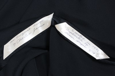 Lot 429 - A slinky black bias-cut satin evening gown, a...