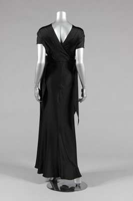 Lot 429 - A slinky black bias-cut satin evening gown, a...