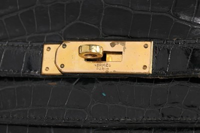 Lot 53 - An Hermès black crocodile Kelly bag, 1963,...