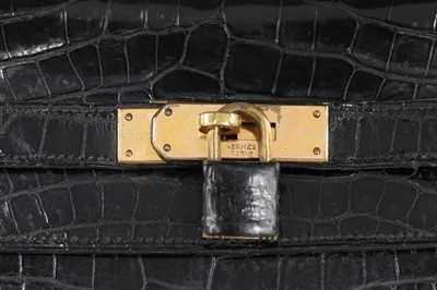 Lot 53 - An Hermès black crocodile Kelly bag, 1963,...