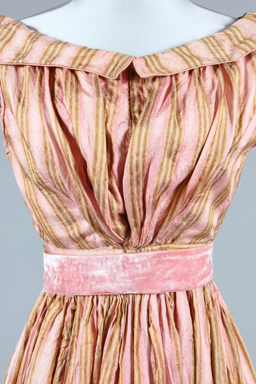 Lot 26 An ivory figured silk dress, circa 1820, the