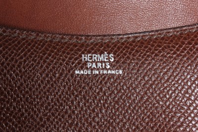 Lot 69 - An Hermès brown leather belt with pouch,...