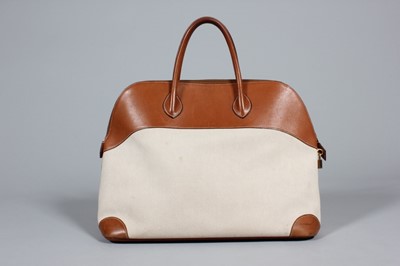 Lot 72 - An Hermès Bolide travel bag, of canvas and tan...
