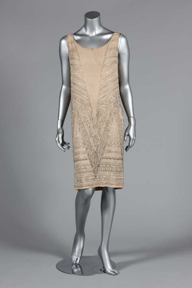 Lot 111 - A beaded ivory chiffon flapper dress, circa...