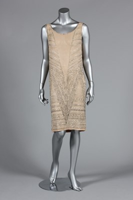 Lot 111 - A beaded ivory chiffon flapper dress, circa...