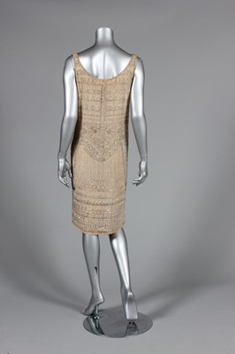 Lot 111 - A beaded ivory chiffon flapper dress, circa...