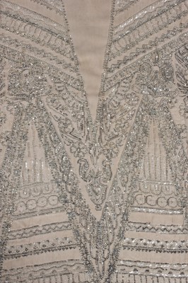 Lot 111 - A beaded ivory chiffon flapper dress, circa...