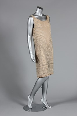 Lot 111 - A beaded ivory chiffon flapper dress, circa...