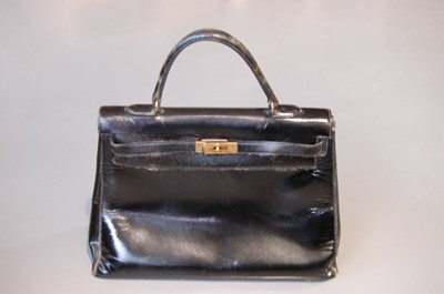 Lot 190 - An Hermès black patent leather Kelly bag,...