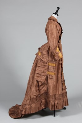 Lot 241 - A brown taffeta and gold satin trimmed gown...