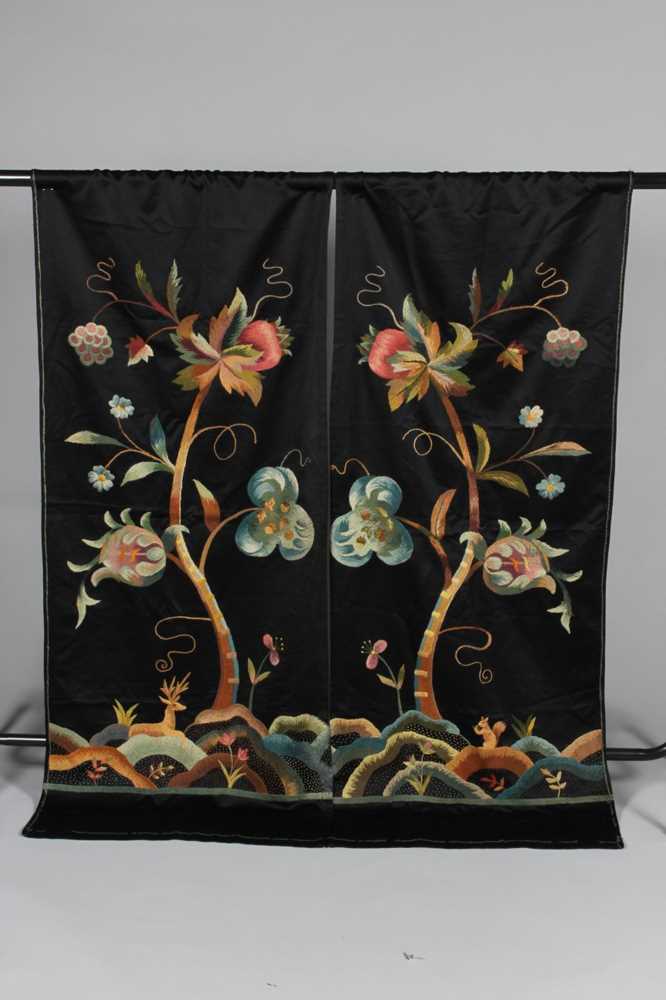 Lot 319 - A pair of crewel worked black satin curtains,...