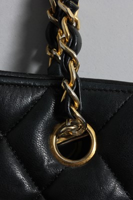 Lot 312 - A Chanel quilted black leather shopper, 1980s,...