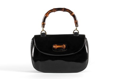 Lot 139 - A Gucci black patent leather handbag with cane...