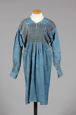 Lot 9 - A blue calico farmer's smock, circa 1900,...