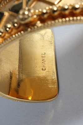 Lot 28 - A Chanel gilt bangle, 1980s, marked Chanel,...