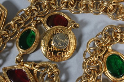 Lot 36 - A Chanel gem-inset belt, signed, with pendants...